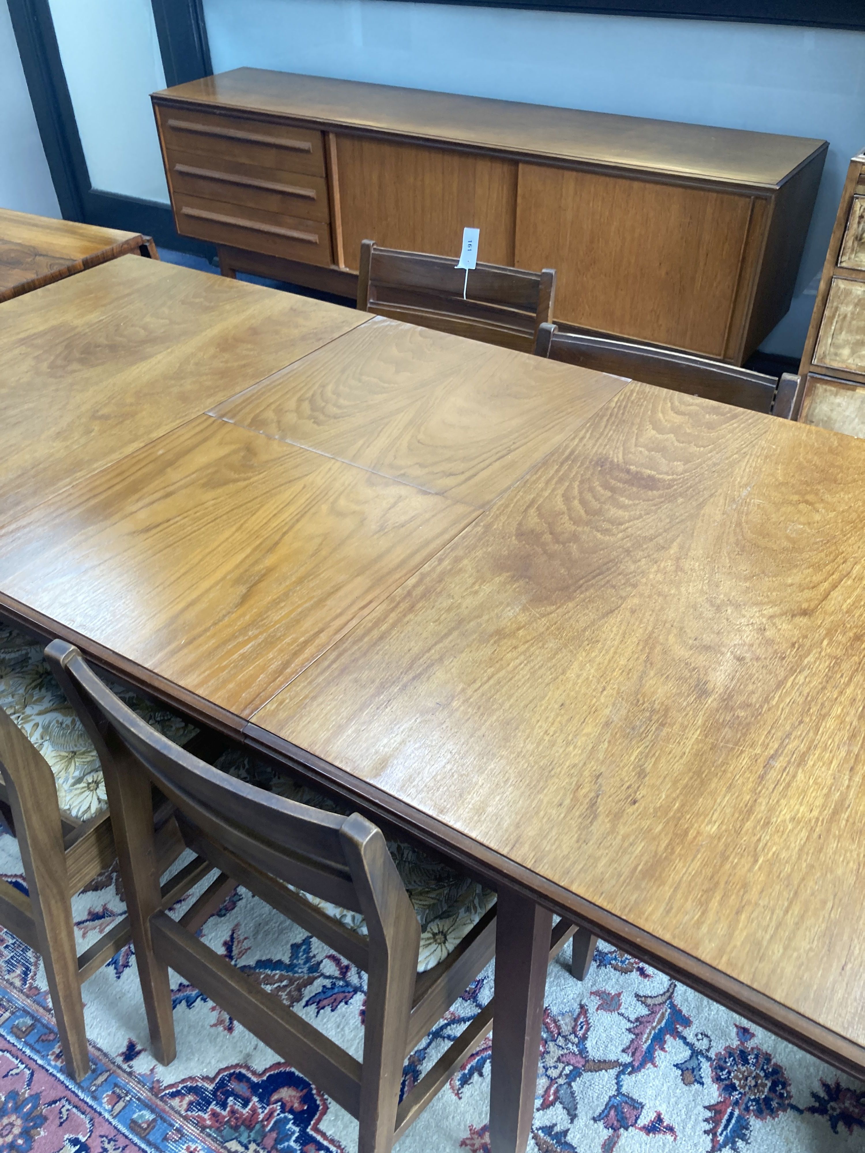 A White and Newton teak dining table, length 168cm extended, width 84cm, height 72cm together with four dining chairs height 71 cm. and